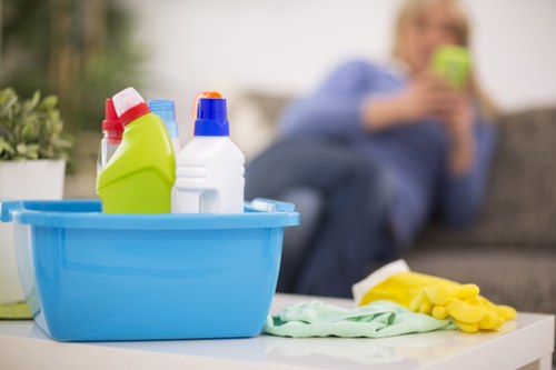Local cleaners working in a Hepherdsbush apartment kitchen and bathroom